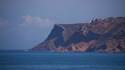 Roca Cape (Cabo da Roca) over ocean viewed from Arriba beach in Cascais in a sunny and beautiful day