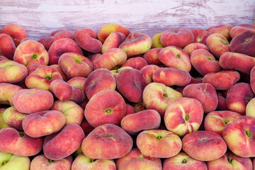 Paraguayan sweet peaches stacked in a container box to the raw for sale.
