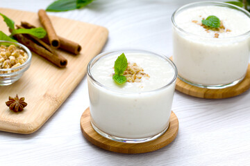 milkshake with walnut pieces and a sprig of fresh mint. gealthy eating