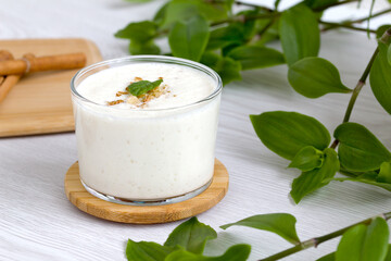 Obraz na płótnie Canvas milkshake with walnut pieces and a sprig of fresh mint. gealthy eating