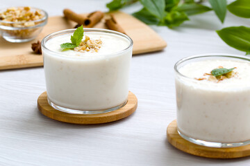 milkshake with walnut pieces and a sprig of fresh mint. gealthy eating
