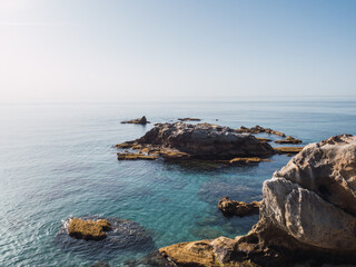 Mediterranean coast cove with turquoise waters and blue sky in Manilva, Costa del Sol, Spain