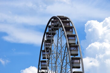giant ferris wheel detail. white gondolas. steel frame construction. giant spokes in large wheel....