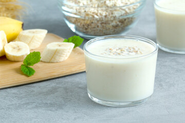 milkshake on the background of cereal flakes and ripe bananas