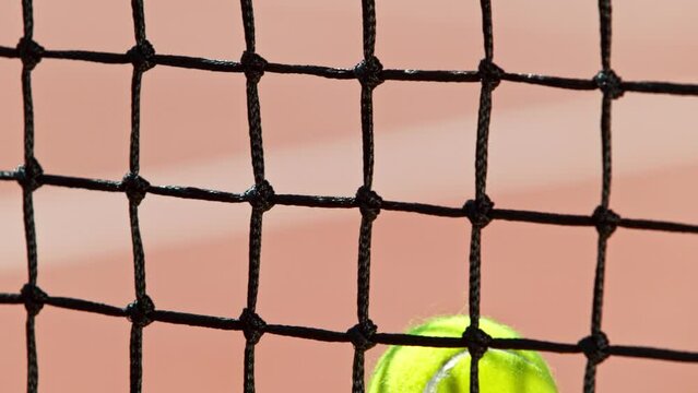 Super slow motion of hitting tennis ball into a net. Low depth of focus. Filmed on high speed cinema camera, 1000fps.