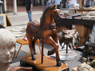 Flea market. Vintage wooden horse on wheels.