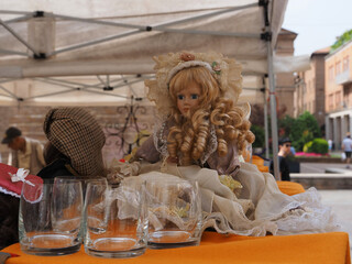 Flea market. Vintage doll with blond curls for sale.