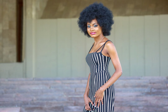 Fashionable and beautiful African women in striped clothes posing