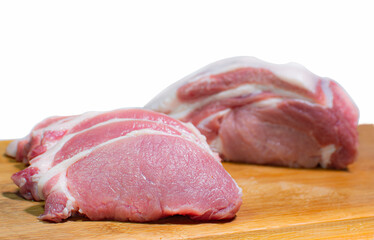 Pork, red meat, pork loin, with a layer of fat inserted. Cut into cubes. Fresh pork cut into slices On a wooden chopping board, place it on a white surface or background.