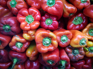 display with red and green peppers in a fruit and vegetable market