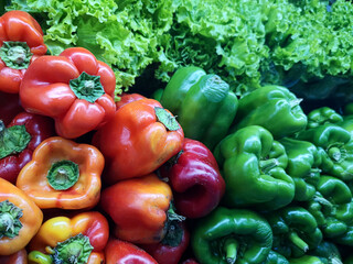 display with red and green peppers in a fruit and vegetable market