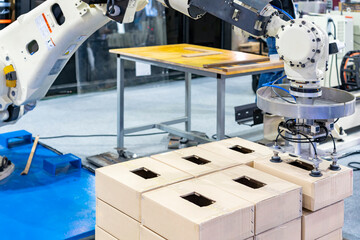 Close up precision robot arm and automatic vacuum pad or suction cup for pick place transport paper box or various material sheet plate product of manufacturing in industrial