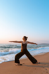 Fototapeta na wymiar young girl doing yoga by the sea