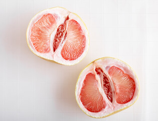 Top view flat lay pomelo fruit on white ceramic tiles.