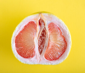 Top view ripe juicy grapefruit on yellow background.