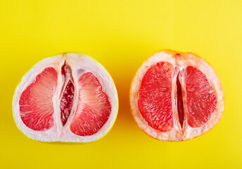 Top view pomelo fruit and grapefruit halves on yellow background.
