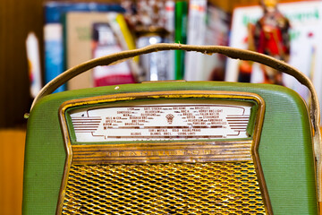 Very old radio in a room with books