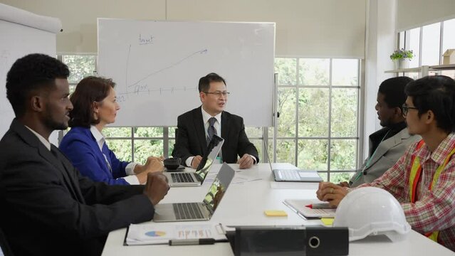 Asian Businessman Talking with Parters in Meeting of International Construction Corporate. Diversity in Business Concept