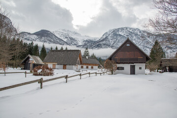 Cottages in winter with fog and mist and clouds.