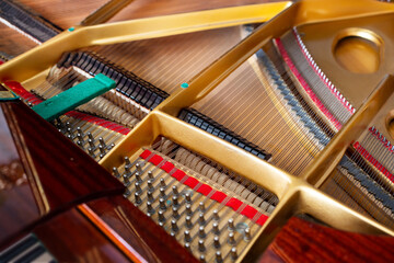 Close-up, top view, of the internal string structure of a top grand piano.