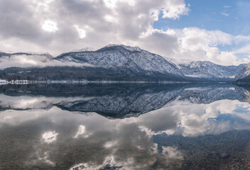 Beautiful winter reflections at Lake Bohinj in Slovenia. National park in winter. 