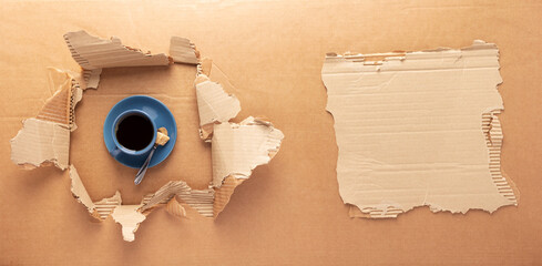 Cup of coffee and beans on brown cardboard paper background. Relax coffee concept
