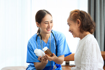 Fototapeta premium Female doctor comes to talk to elder patient in the hospital about the medical diagnosis. 
