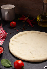 Pizza or dough for bread with ingredients at table. Pizza recipe homemade at tabletop background