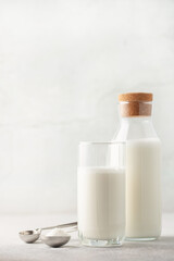 Drink from dry vegan vegetable milk in a glass and bottle. - obrazy, fototapety, plakaty