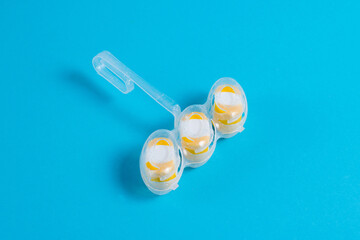 Means for disinfection and washing of a toilet bowl, toilet block of white yellow color on a blue background with copy space