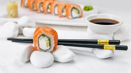 Japanese cuisine. Philadelphia roll with salmon on a white table.    © Борис Яценко