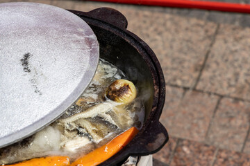 Fototapeta premium the cauldron in which the Ear is cooked. Carrots, fish and onions are visible