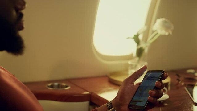 Serious manager using smartphone charts. Closeup hands holding cell phone.