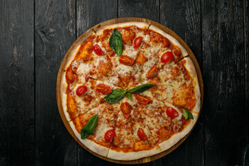 Italian cuisine. Pizza on a black table
