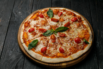 Italian cuisine. Pizza on a black table
