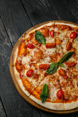 Italian cuisine. Pizza on a black table
