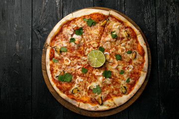 Italian cuisine. Pizza on a black table
