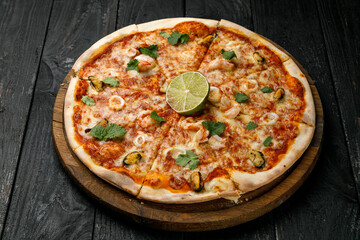 Italian cuisine. Pizza on a black table

