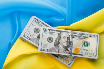 dollars against the background of the Ukrainian flag. 