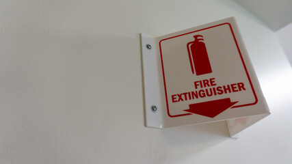 A fire extinguisher sign on the wall