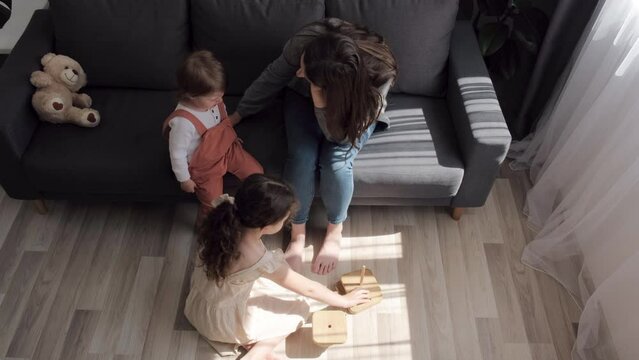 Loving mom consoling or trying make peace with insulted upset stubborn kids daughters avoiding talk, sad resentful girl pouting ignoring caring mother embracing showing support to offended child