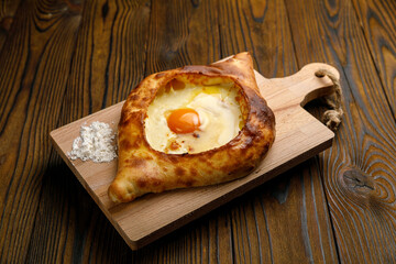 Georgian cuisine. Khachapuri on a wooden table
