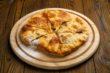 Georgian cuisine. Khachapuri on a wooden table
