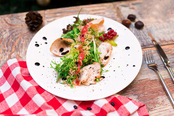 turkey filet salad with couscous, frisée lettuce salad leaves, balsamic sauce and red currant dressing