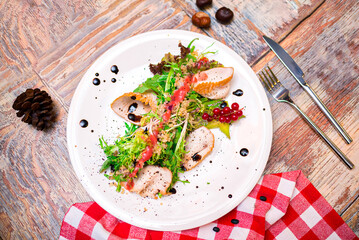 turkey filet salad with couscous, frisée lettuce salad leaves, balsamic sauce and red currant dressing