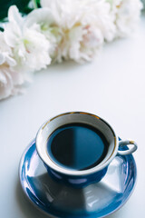 Obraz na płótnie Canvas Cup of coffee, peonies on white background 