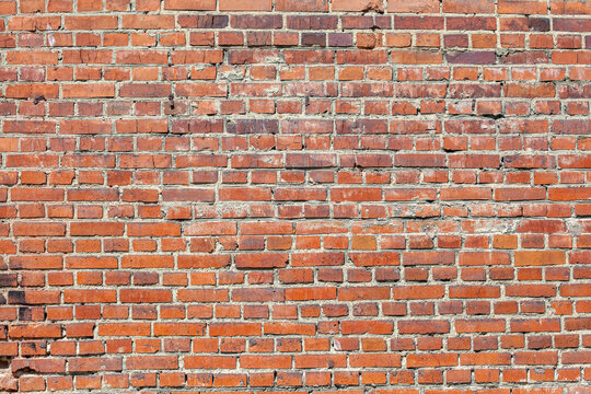 Red brick wall, old brick, grunge texture background. A wall with a walled-up window opening.