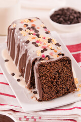 Sponge cake with white frosting and sugars.