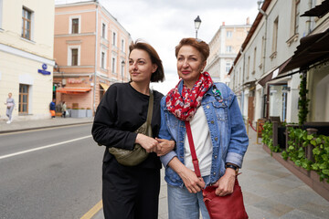 adult daughter and mother walking in the city       