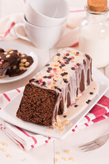 Sponge cake with white frosting and sugars.